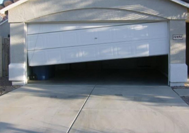 garage door off track repair in in Northridge